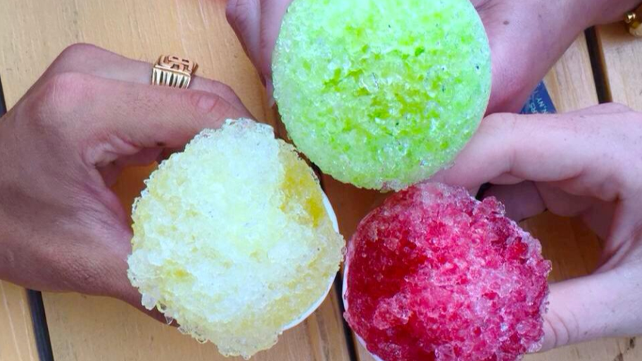 Hands holding alcoholic snow cones at Branch Ofc Brooklyn NY