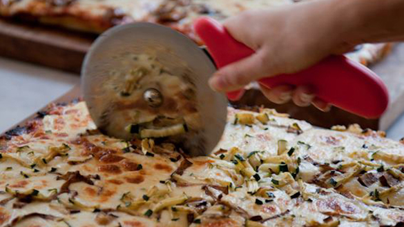 Sardo Pizza being sliced